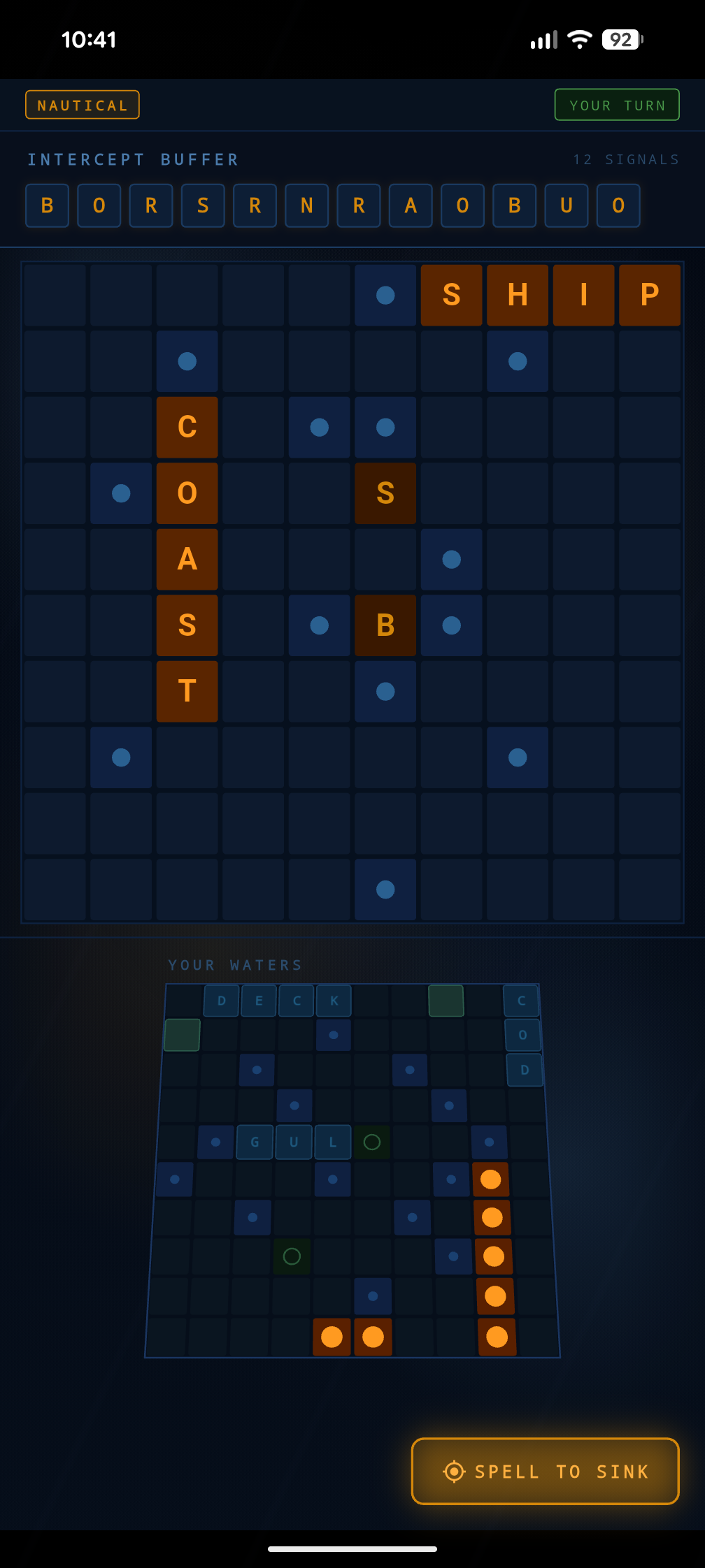 Mid-battle: amber letters revealed across the enemy grid, your waters below, SPELL TO SINK ready.